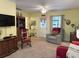 Living room featuring a red sofa, chair, and wooden furniture on carpeted flooring at 712 Honeysuckle Ln, Temple, GA 30179
