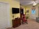 Cozy living room with television, comfortable seating, carpeted flooring, and light yellow walls at 712 Honeysuckle Ln, Temple, GA 30179