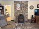 Charming living room with a stone fireplace and an inviting view to the next room at 712 Honeysuckle Ln, Temple, GA 30179