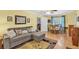 A living room with comfortable seating, a ceiling fan, and multiple doorways leading to other areas of the home at 712 Honeysuckle Ln, Temple, GA 30179