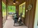Inviting porch with ceiling fan and comfortable rocking chairs, creating a relaxing outdoor space at 712 Honeysuckle Ln, Temple, GA 30179