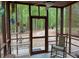 Enjoyable screened-in porch with wooded views, ceiling fan, and furniture at 712 Honeysuckle Ln, Temple, GA 30179