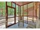 Cozy screened-in porch featuring comfortable seating, natural light, and peaceful views of the surrounding landscape at 712 Honeysuckle Ln, Temple, GA 30179