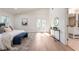 Large bedroom with balcony access, hardwood floors, a white interior, and a partial view of the bathroom at 1363 Diamond Se Ave, Atlanta, GA 30316