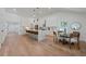Open concept kitchen with stainless steel appliances, island with bar stool seating, and adjacent dining area at 1363 Diamond Se Ave, Atlanta, GA 30316