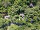 Aerial view of a property with a home surrounded by lush trees, showcasing its location and lot size of 1.149 acres at 4673 Jefferson Township Pl, Marietta, GA 30066