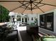 Outdoor deck with comfortable seating and an umbrella, creating a relaxing space for enjoying the backyard view at 4673 Jefferson Township Pl, Marietta, GA 30066