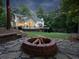 Beautiful backyard featuring a fire pit area, lush greenery, and a spacious lawn, perfect for outdoor activities at 4673 Jefferson Township Pl, Marietta, GA 30066