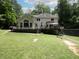 Spacious backyard with a deck, overlooking a well-maintained lawn, bordered by lush trees and a soccer net at 4673 Jefferson Township Pl, Marietta, GA 30066