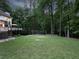 Spacious backyard with a soccer net and a deck, surrounded by lush trees, perfect for recreation and relaxation at 4673 Jefferson Township Pl, Marietta, GA 30066