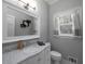 Well-lit bathroom featuring a marble countertop and modern fixtures at 4673 Jefferson Township Pl, Marietta, GA 30066