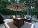Outdoor deck space with seating and lit umbrella at 4673 Jefferson Township Pl, Marietta, GA 30066