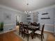 Formal dining room with elegant chandelier, hardwood floors, and stylish decor at 4673 Jefferson Township Pl, Marietta, GA 30066
