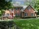 Charming brick home featuring a well-manicured lawn and mature trees offering great curb appeal at 4673 Jefferson Township Pl, Marietta, GA 30066