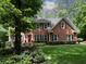Charming brick home featuring a well-manicured lawn and mature trees offering great curb appeal at 4673 Jefferson Township Pl, Marietta, GA 30066