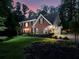 Exterior view of a two-story brick house with a lush front yard and driveway at 4673 Jefferson Township Pl, Marietta, GA 30066