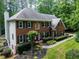 Lovely brick home with lush landscaping, mature trees, and a well-manicured lawn at 4673 Jefferson Township Pl, Marietta, GA 30066