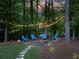 Inviting outdoor fire pit area with Adirondack chairs, creating a perfect space for gatherings under string lights at 4673 Jefferson Township Pl, Marietta, GA 30066