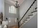 Grand foyer with soaring ceilings, elegant chandelier, staircase, and large windows for natural light at 4673 Jefferson Township Pl, Marietta, GA 30066