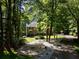 Traditional two-story brick home with a landscaped front yard, framed by mature trees and a winding driveway at 4673 Jefferson Township Pl, Marietta, GA 30066