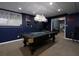 Finished basement boasts a game room with pool table, Houston Astros décor, and adjoining lounge area for relaxation at 4673 Jefferson Township Pl, Marietta, GA 30066