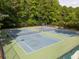 Community tennis courts surrounded by lush trees, providing an active recreational space at 4673 Jefferson Township Pl, Marietta, GA 30066