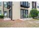 Condo backyard with brick patio, exterior doors and trimmed landscaping for outdoor enjoyment at 5300 Peachtree Rd # 105, Atlanta, GA 30341