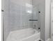 Bright bathroom featuring a shower and tub combination with glass surround at 5300 Peachtree Rd # 105, Atlanta, GA 30341