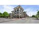Modern building featuring multi-story facade, private balconies, street view, and commercial space at 5300 Peachtree Rd # 105, Atlanta, GA 30341