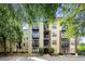 Beautiful condo exterior featuring a modern facade with balconies and lush green trees at 5300 Peachtree Rd # 105, Atlanta, GA 30341