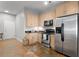 Modern kitchen features stainless steel appliances and light wood cabinetry at 5300 Peachtree Rd # 105, Atlanta, GA 30341