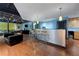 Inviting lounge area featuring bar seating, stainless counters, hardwood floors, and stylish lighting at 5300 Peachtree Rd # 105, Atlanta, GA 30341