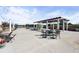 Outdoor patio with pergola, string lights, dining tables, and ample seating at 5300 Peachtree Rd # 105, Atlanta, GA 30341