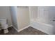 Bathroom with a white toilet, tub and tile flooring at 7055 Blairs View Dr # 1, Austell, GA 30168