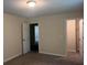 Bedroom with an open doorway and closet, features neutral walls and carpet at 7055 Blairs View Dr # 1, Austell, GA 30168