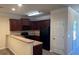 View of kitchen with rich wood cabinets, black appliances, and breakfast bar at 7055 Blairs View Dr # 1, Austell, GA 30168