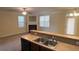 View of open-concept living space with kitchen sink, windows, and fireplace at 7055 Blairs View Dr # 1, Austell, GA 30168