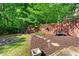 Private backyard with a firepit, stepping stones, and manicured landscaping at 931 Windsor Creek Dr, Grayson, GA 30017