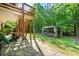 Secluded backyard with a stone patio and wooden gazebo, perfect for outdoor relaxation at 931 Windsor Creek Dr, Grayson, GA 30017