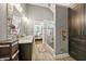 Bright bathroom featuring dual vanity, glass shower, and playful wall decor with an open view to the bedroom at 931 Windsor Creek Dr, Grayson, GA 30017