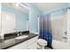 Well-lit bathroom featuring a shower-tub combo and a marble countertop sink at 931 Windsor Creek Dr, Grayson, GA 30017