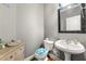 Charming half-bathroom with light grey walls, an ornate mirror, and whimsical beach-themed decor at 931 Windsor Creek Dr, Grayson, GA 30017