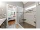 Contemporary bathroom featuring a seamless glass shower, adjacent to a spacious vanity area and bright bedroom view at 931 Windsor Creek Dr, Grayson, GA 30017