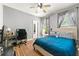 Comfortable bedroom with a bed, desk, and windows providing plenty of natural light at 931 Windsor Creek Dr, Grayson, GA 30017