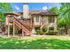 Home exterior with wood deck and stairs leading to a large backyard at 931 Windsor Creek Dr, Grayson, GA 30017