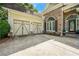 View of the attached garage and entrance with stone and siding at 931 Windsor Creek Dr, Grayson, GA 30017