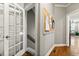Inviting hallway with hardwood floors, a decorative cork board, and doorways leading to other rooms at 931 Windsor Creek Dr, Grayson, GA 30017