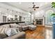 Open-concept living room adjacent to the kitchen, featuring hardwood floors and a stone fireplace at 931 Windsor Creek Dr, Grayson, GA 30017