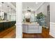 Open living area features hardwood floors, fireplace, arched windows, and seamless flow to kitchen at 931 Windsor Creek Dr, Grayson, GA 30017