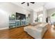 Spacious living room showcasing hardwood floors, modern decor, and abundant natural light from large windows at 931 Windsor Creek Dr, Grayson, GA 30017